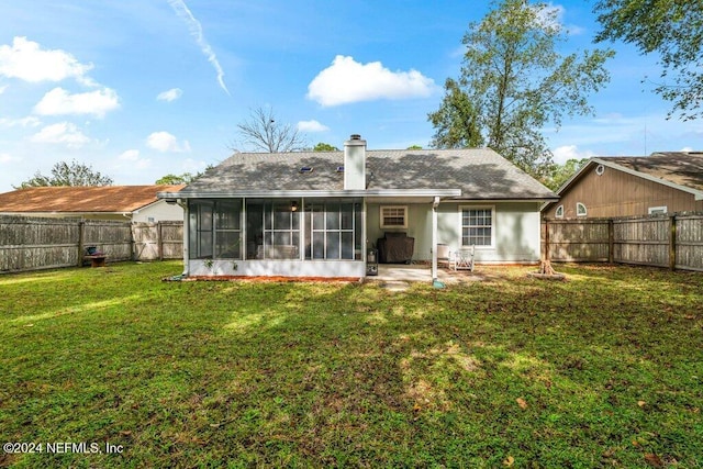 back of house with a sunroom, a yard, and a patio