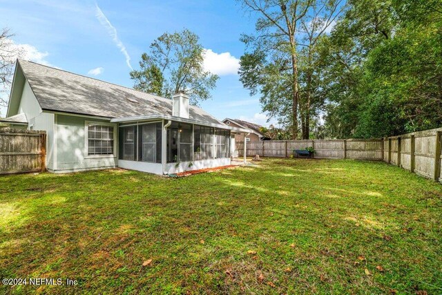 view of yard with a sunroom