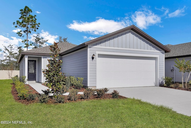 view of front facade featuring a garage and a front lawn