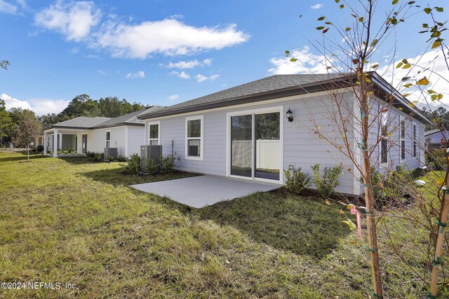 back of house featuring a lawn, a patio area, and cooling unit