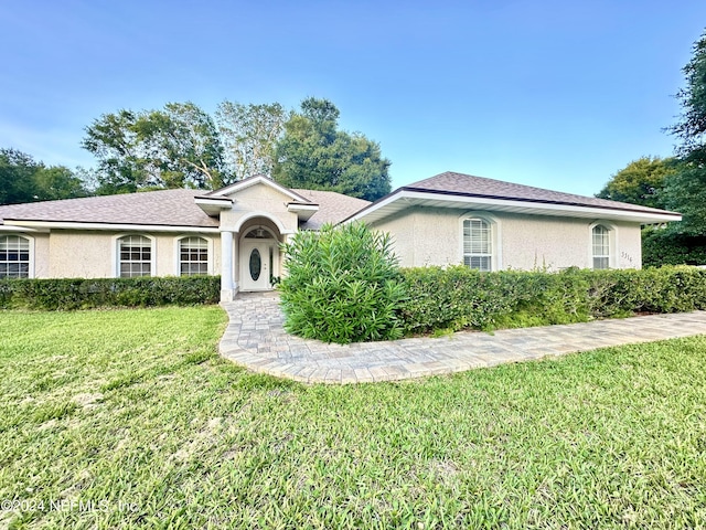 ranch-style home featuring a front lawn