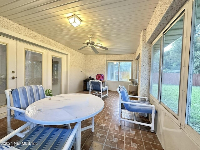 sunroom / solarium with ceiling fan and vaulted ceiling