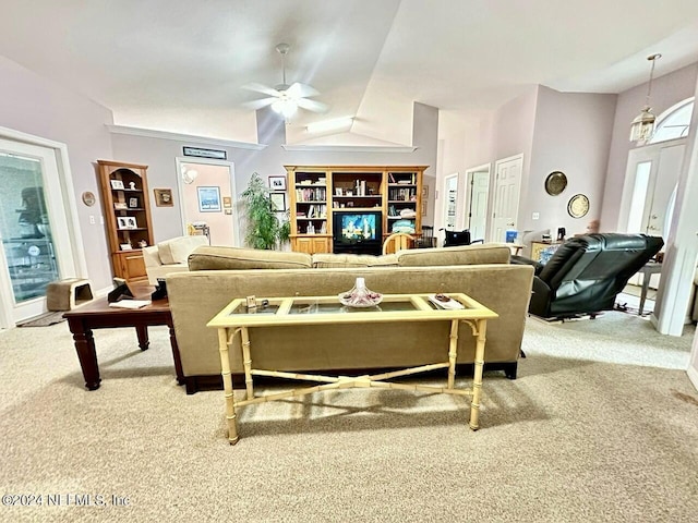 living room featuring ceiling fan, light carpet, and vaulted ceiling