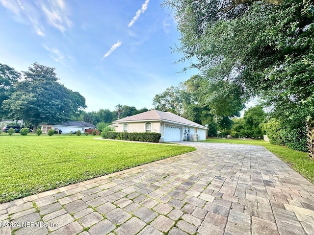 view of side of home with a garage and a lawn