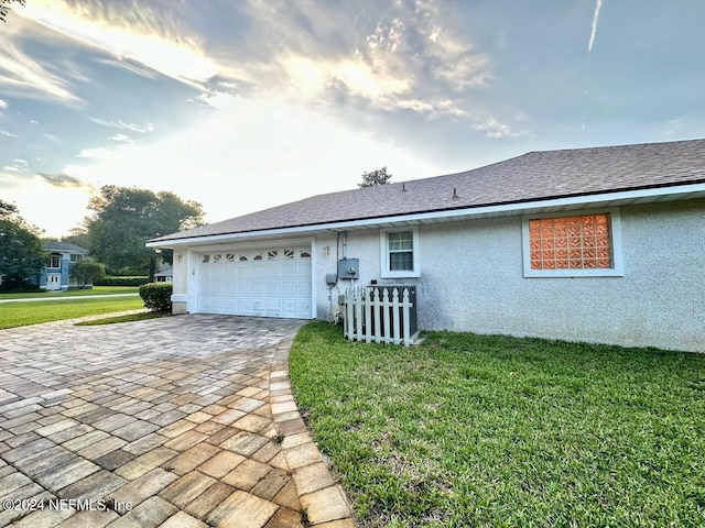 view of front of house with a garage and a front lawn