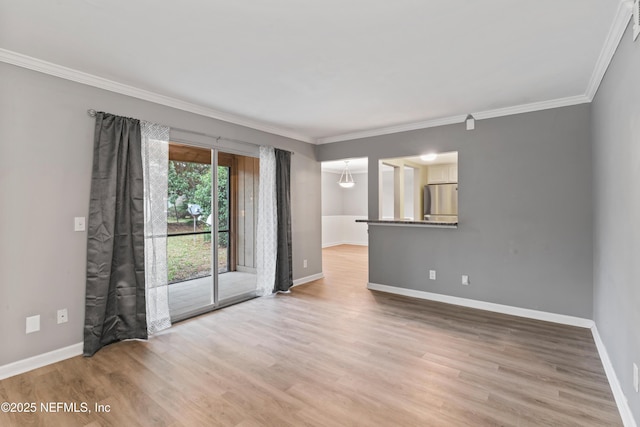 unfurnished room featuring wood-type flooring and ornamental molding