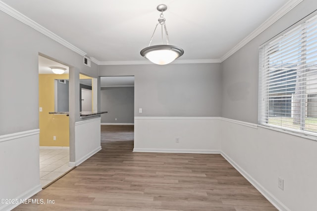 unfurnished dining area featuring wood-type flooring and ornamental molding