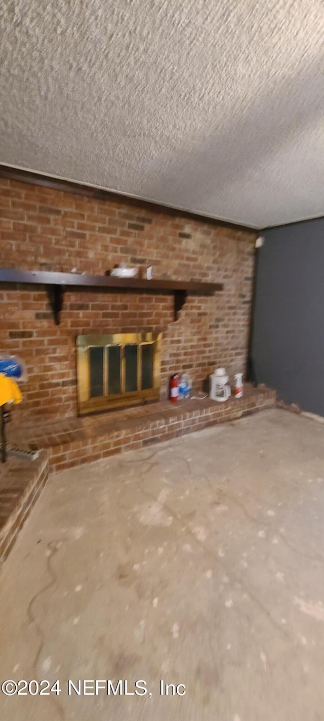 unfurnished living room with a textured ceiling and a fireplace