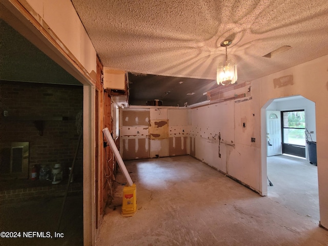 interior space with white cabinetry and pendant lighting