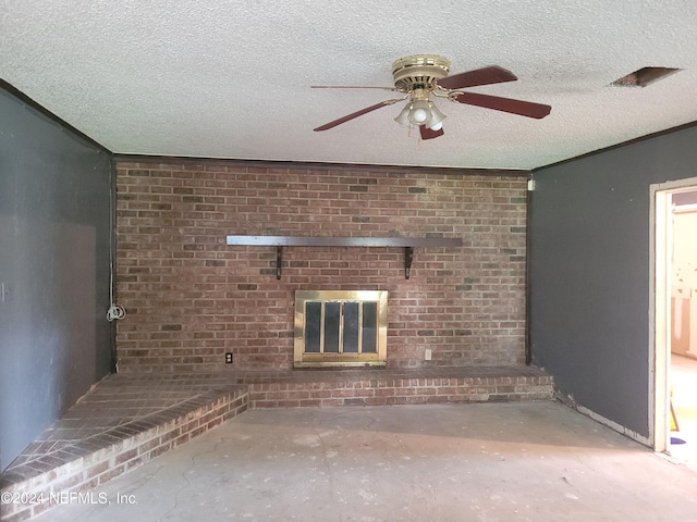 unfurnished living room with ceiling fan, a fireplace, a textured ceiling, concrete flooring, and crown molding