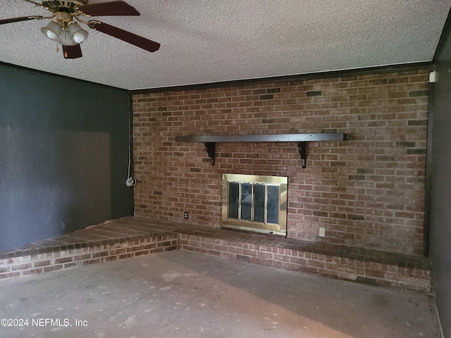 unfurnished living room featuring a textured ceiling, ceiling fan, concrete flooring, and a fireplace