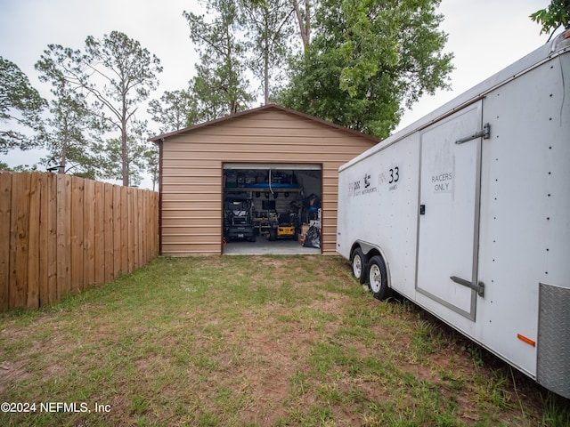 garage featuring a lawn