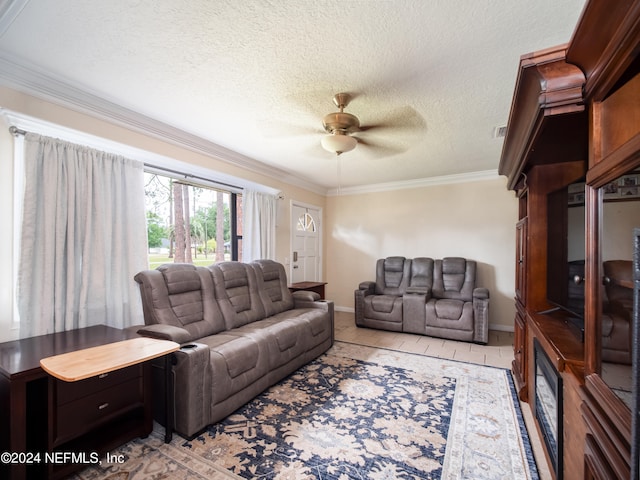 tiled living room featuring a textured ceiling, ornamental molding, and ceiling fan