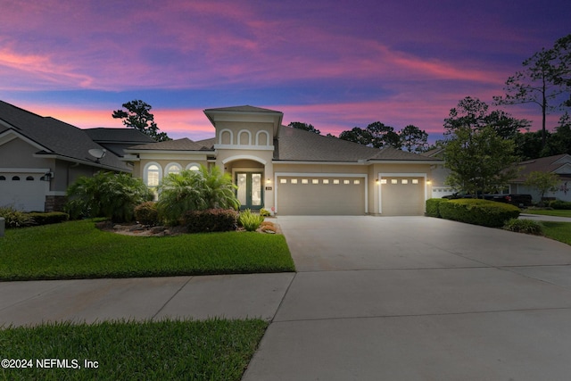 view of front facade featuring a lawn and a garage