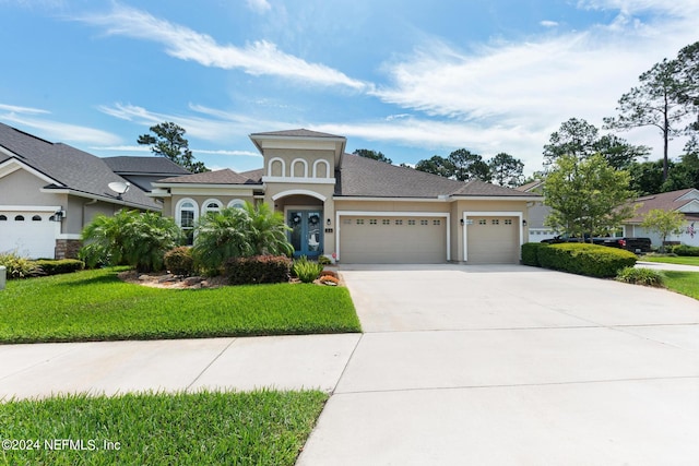 view of front facade featuring a front yard and a garage