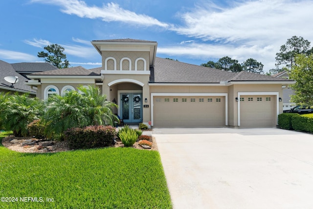 view of front of house with a garage and a front yard