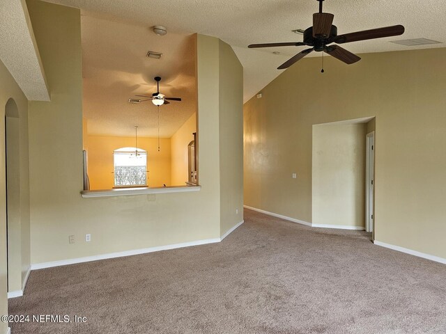 interior space with ceiling fan, a textured ceiling, and lofted ceiling