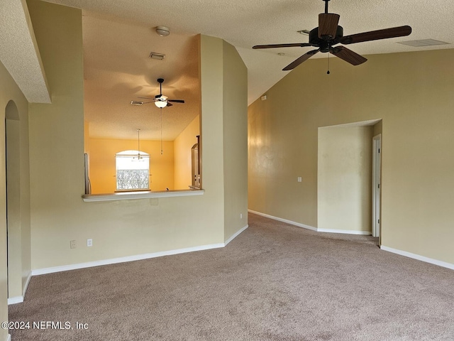 empty room with lofted ceiling, a textured ceiling, carpet, and baseboards