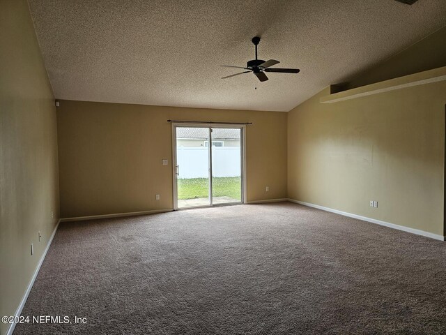 carpeted empty room featuring lofted ceiling, a textured ceiling, baseboards, and a ceiling fan