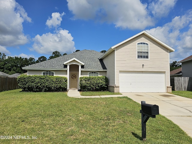 view of front of home with a garage and a front yard