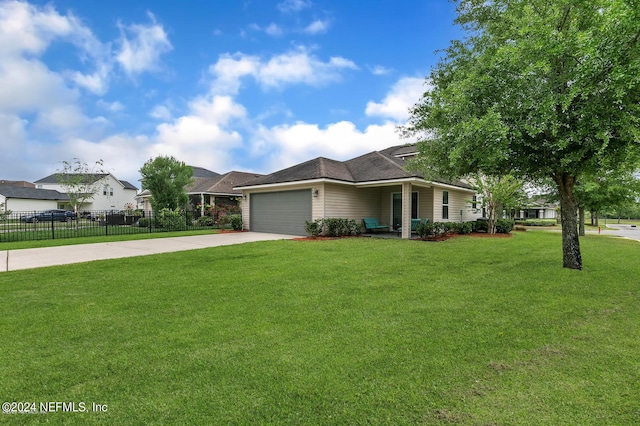 view of front facade featuring driveway, a garage, fence, and a front lawn