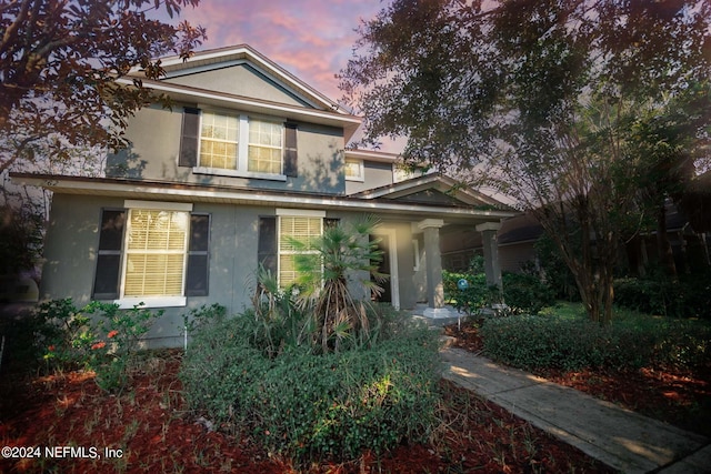 traditional-style house featuring stucco siding