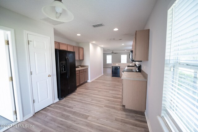 kitchen with light wood finished floors, recessed lighting, light countertops, visible vents, and black appliances