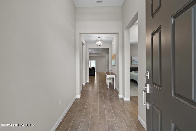 hallway with a notable chandelier