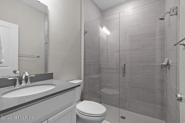 bathroom with vanity, an enclosed shower, and toilet