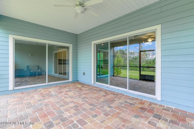 unfurnished sunroom with ceiling fan