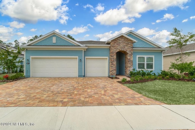 view of front of home with a garage and a front lawn