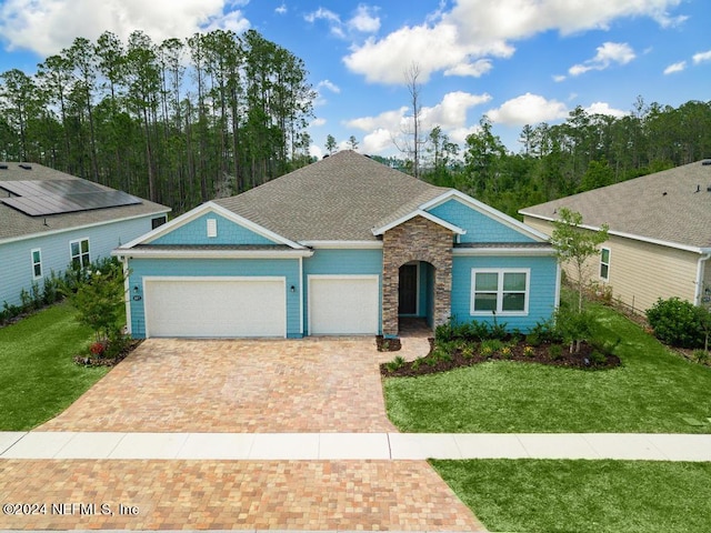 view of front of house with a front lawn and a garage