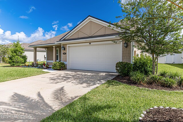 single story home with a front lawn and a garage