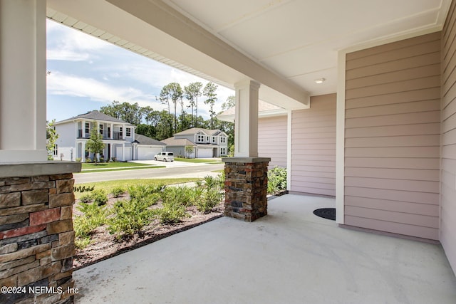 view of patio with a porch and a garage