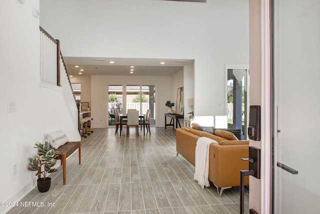 living room featuring a towering ceiling