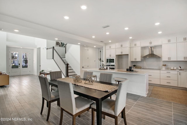 dining space featuring light hardwood / wood-style flooring and french doors