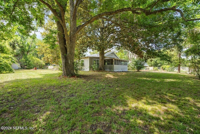 view of yard with a sunroom