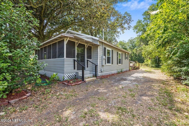 view of front of home featuring a sunroom