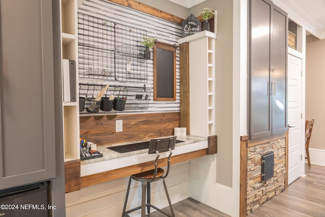 kitchen with a kitchen bar and light wood-type flooring