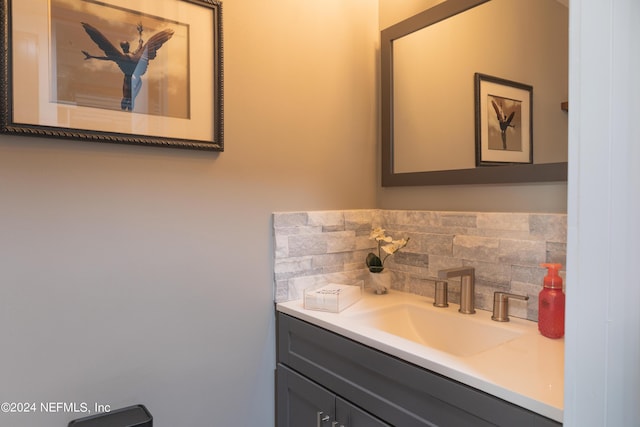 bathroom featuring vanity and backsplash