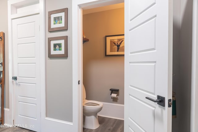 bathroom with toilet and hardwood / wood-style floors