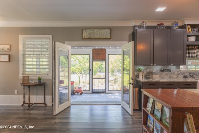 entryway featuring dark wood-type flooring, ornamental molding, and french doors