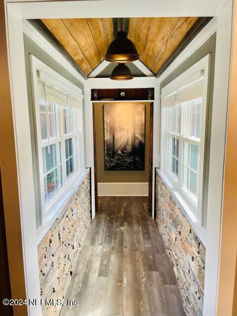 entryway featuring wood ceiling, vaulted ceiling, wood-type flooring, and a wealth of natural light