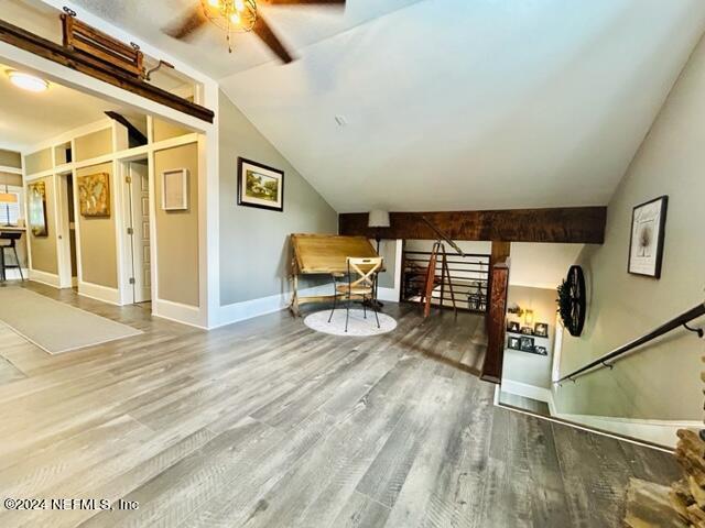 bonus room with ceiling fan, lofted ceiling, and wood-type flooring