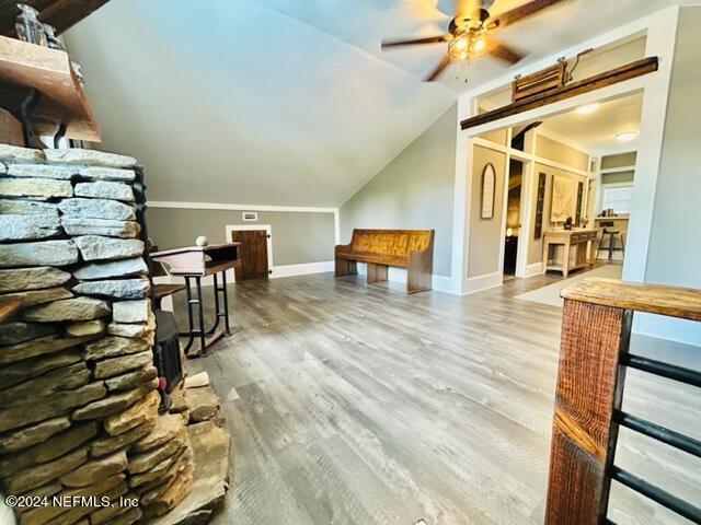 additional living space with wood-type flooring, ceiling fan, and vaulted ceiling