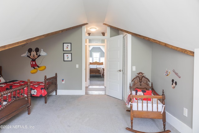 bedroom featuring lofted ceiling and carpet floors