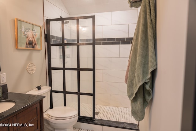 bathroom featuring a tile shower, vanity, and toilet