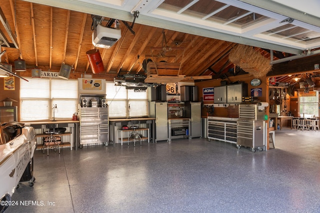 garage featuring a garage door opener and a workshop area