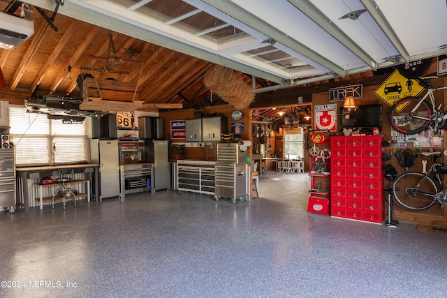 garage featuring a garage door opener and a workshop area