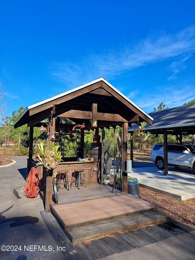 view of property's community with a gazebo and an outdoor bar